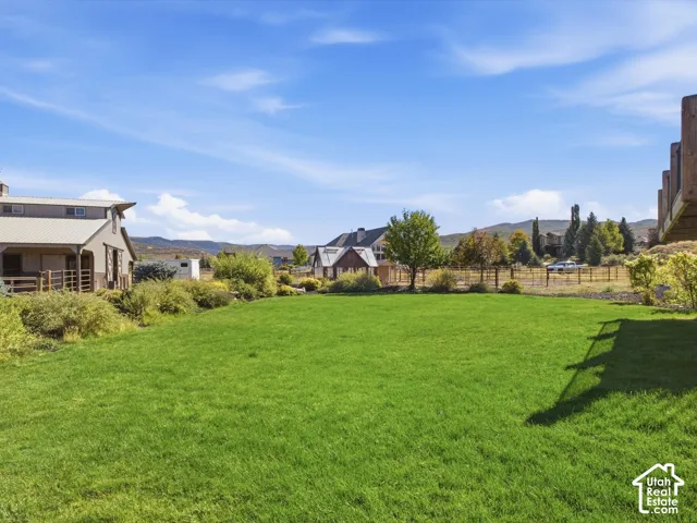 Expansive grassy area with distant mountainous terrain