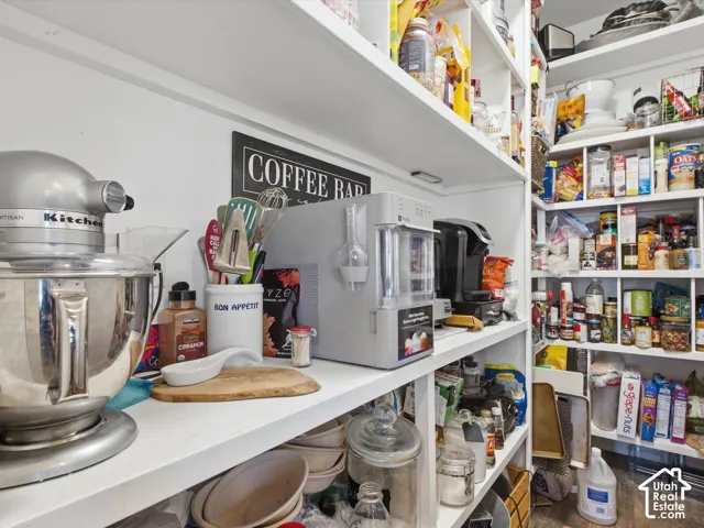 Built-in pantry shelving featuring white finishes and an L-shaped configuration