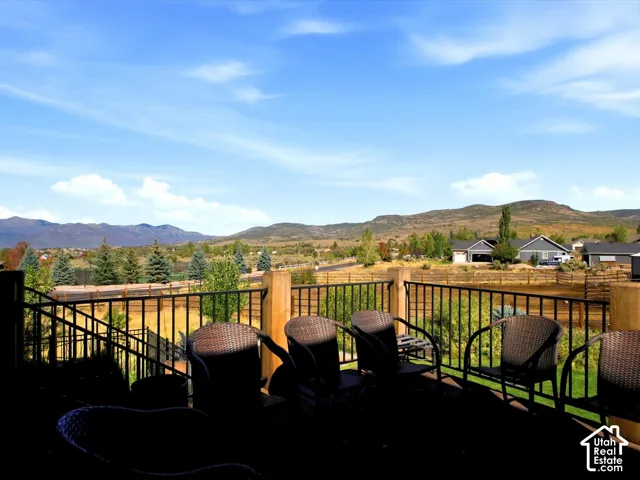 Outdoor deck with black metal railing and wooden posts