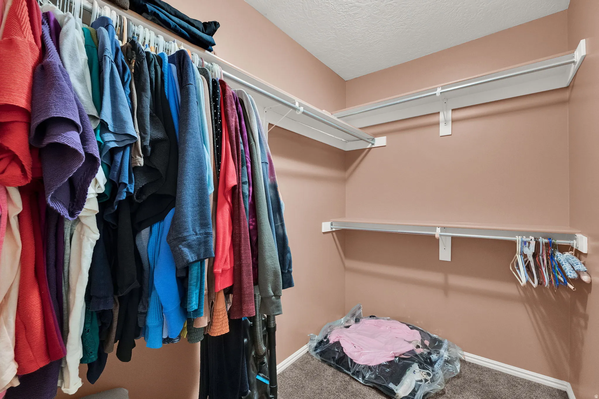 Custom closet system featuring multiple rods and shelving