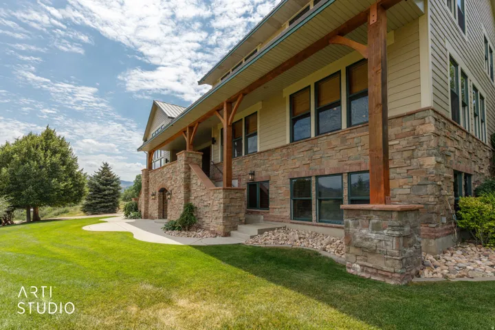 Stone veneer foundation with exposed wood beams