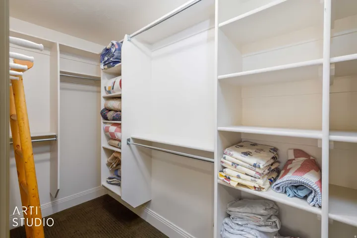 Large walk-in closet. Integrated shelving, and built-in storage solutions