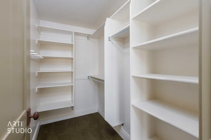 Spacious walk-in closet with built-in shelving units.