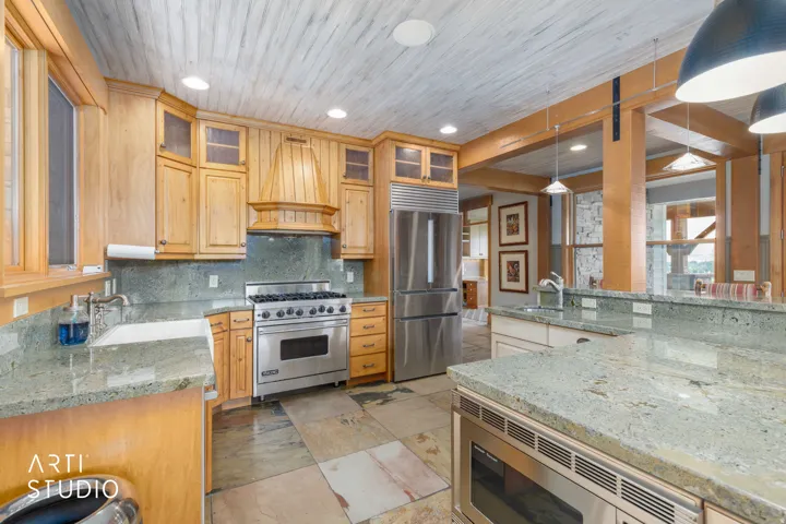 Alder cabinetry, granite countertops, stainless steel appliances, and slate flooring.