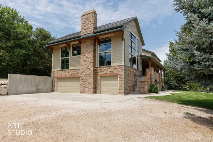 3- car oversized garage. Stone and hardiplank siding exterior, with a prominent stone chimney.