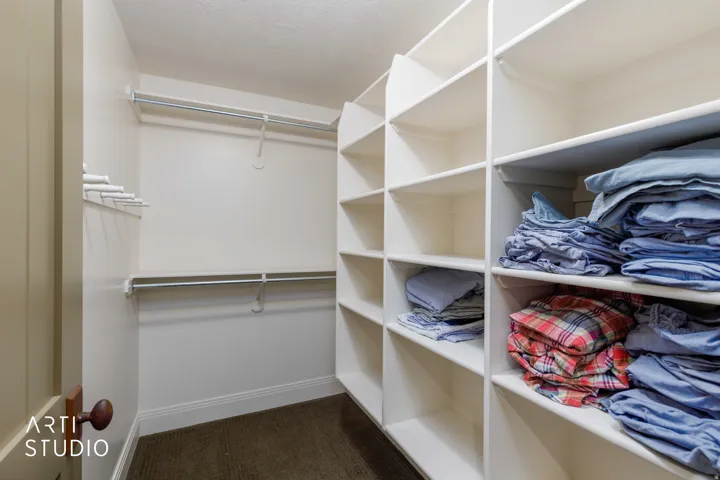 Boys spacious bunk room closet with tons of built-in shelving.