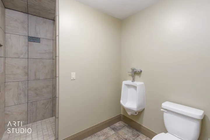 Boys bunk bath walk-in tile shower, toilet room featuring standing urinal for the boys!!