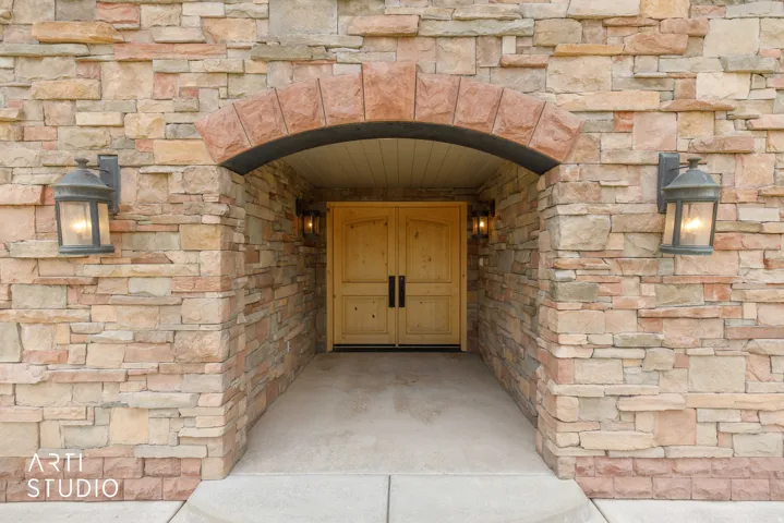 Stone veneer exterior with an arched entryway