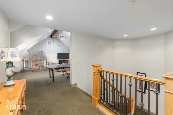 View of recreation room and vaulted ceiling.