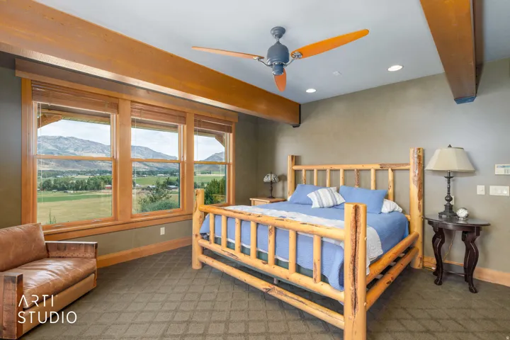 Master bdrm. Stunning views, Exposed wood ceiling beams, wood cased windows, custom moldings, recessed lighting, lodgepole pine bed