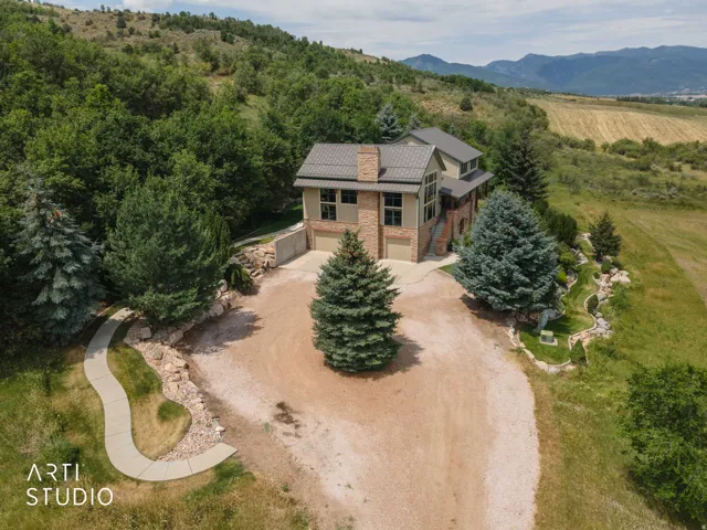 Multi-level residence featuring stone and hardiplank siding, a large multi-car garage.