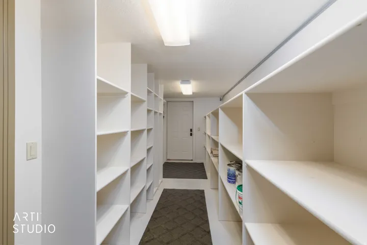 Extensive built-in storage shelving from garage entrance.
