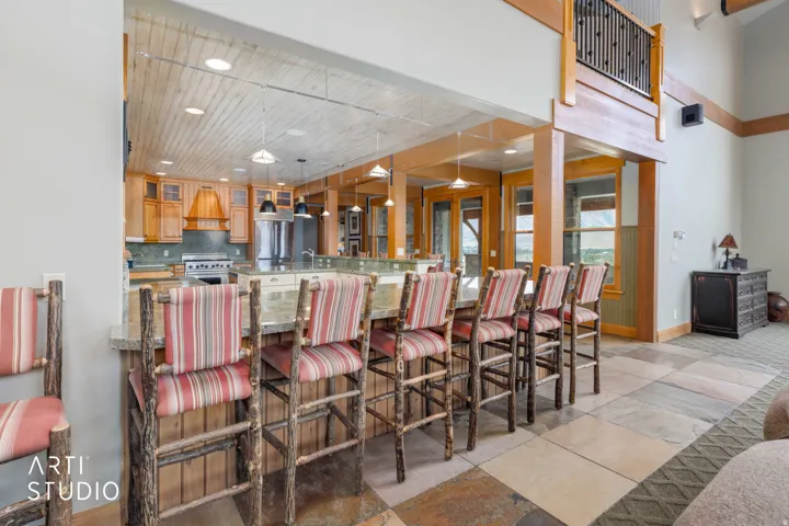 View to the kitchen from the great room. Tons of seating!