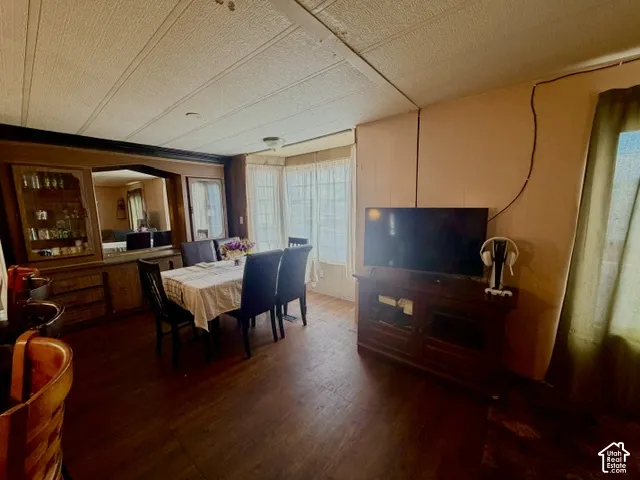 Wood-finish flooring throughout, featuring a built-in wooden display cabinet and a bay window