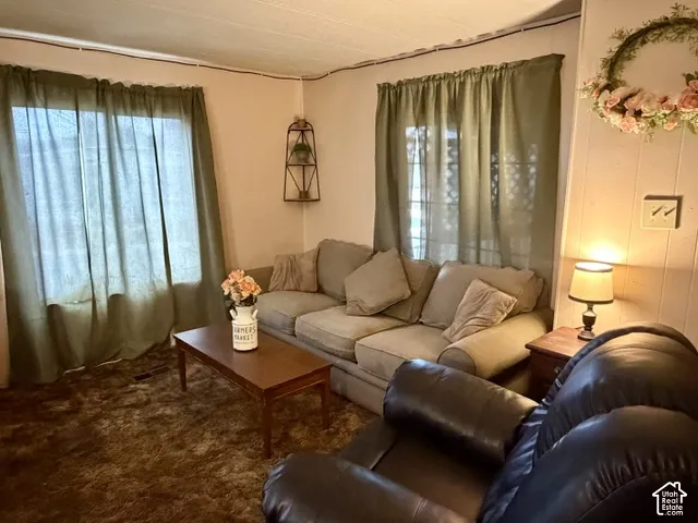 Wall-mounted shelving unit, wood-finish coffee table, and a wood-finish end table