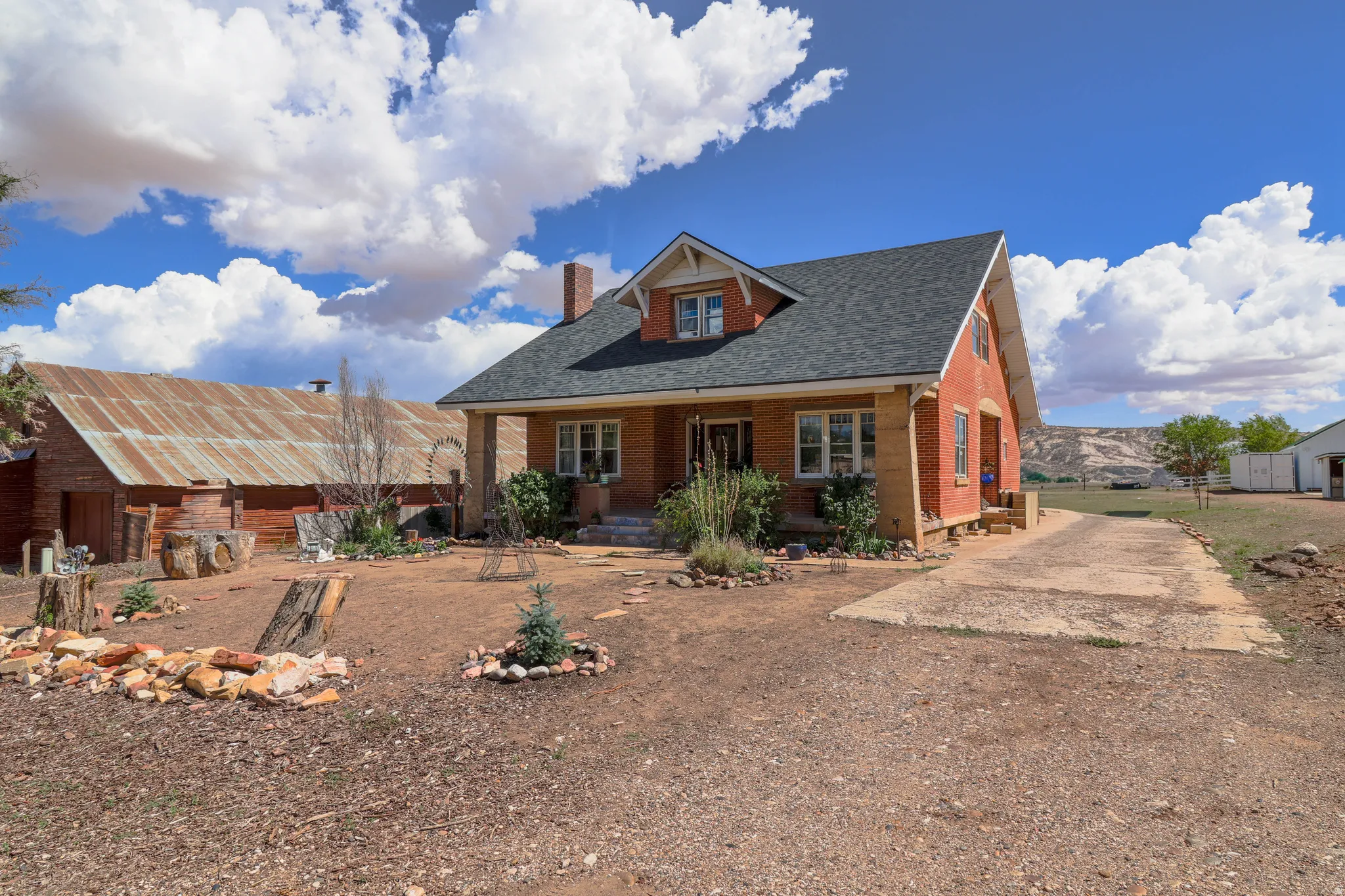 Brick exterior with a shingle roof and a concrete driveway
