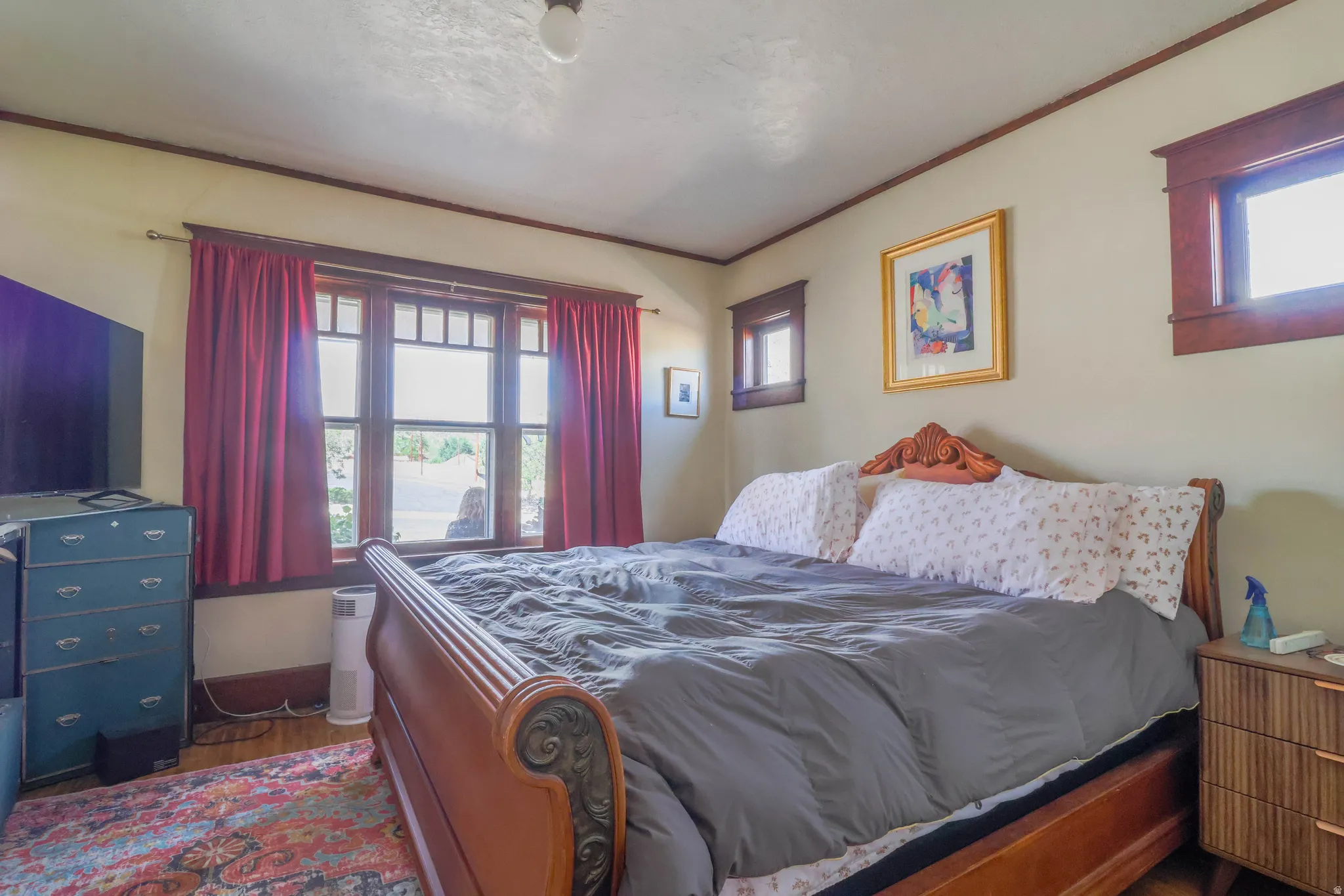Wood-finish flooring with multiple windows and wood trim accents
