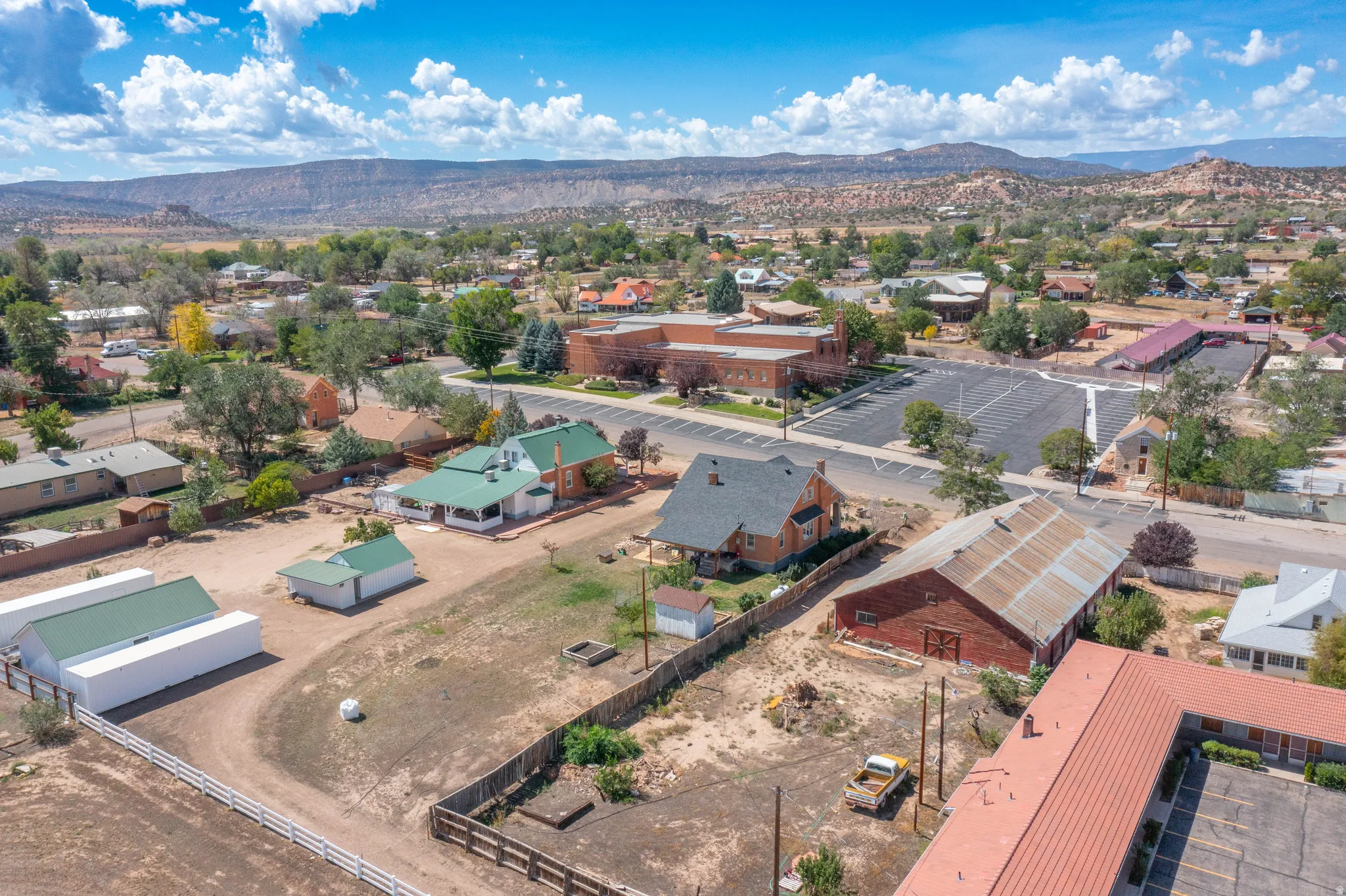 Expansive lot featuring multiple outbuildings, fenced perimeters, and established residential structures