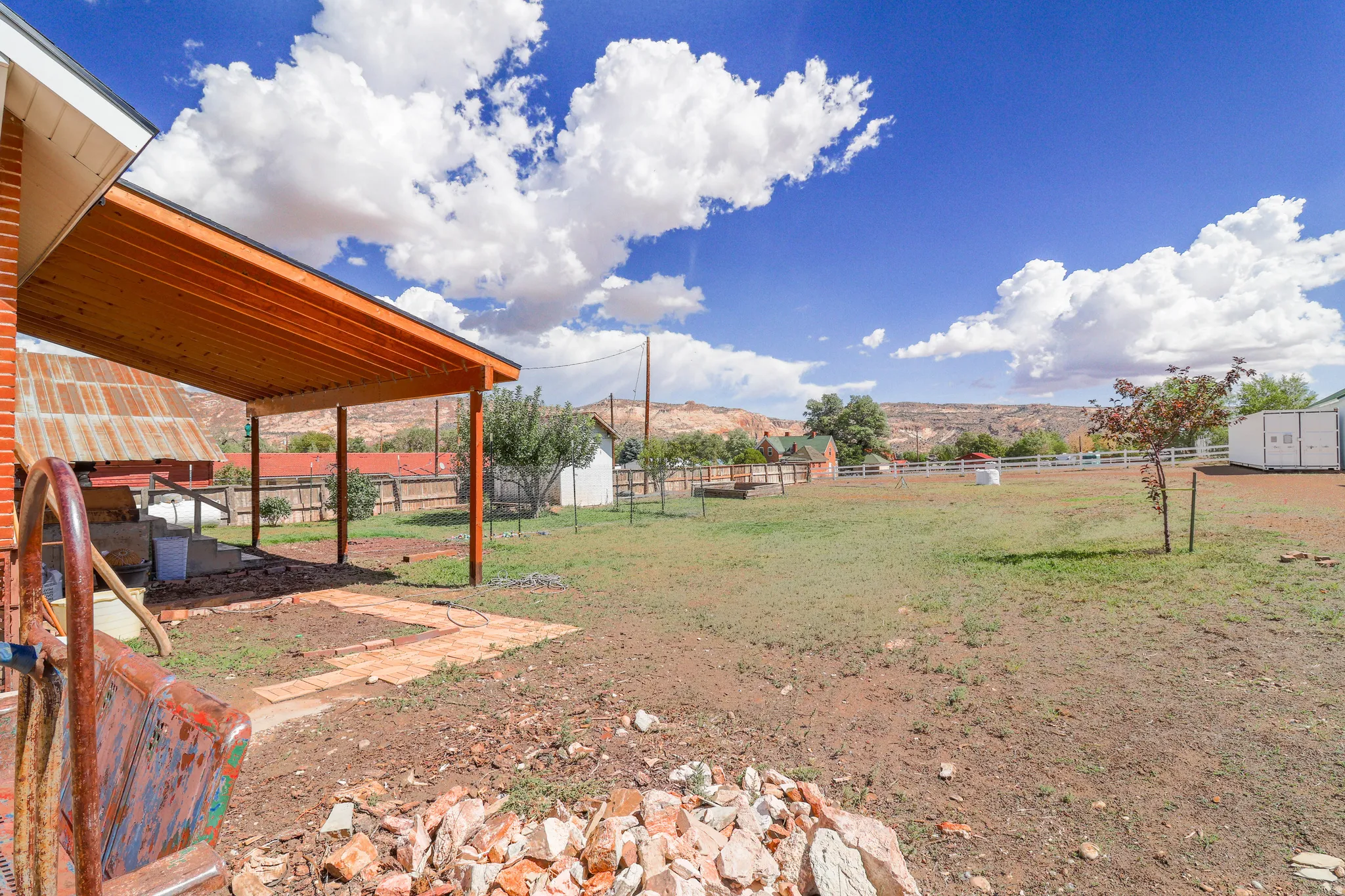 Covered patio area with wood ceiling and brick patio