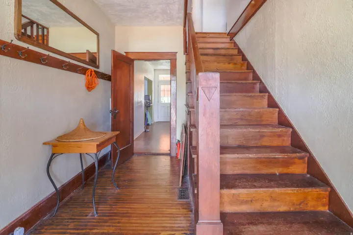 Hardwood flooring and staircase with wood newel post