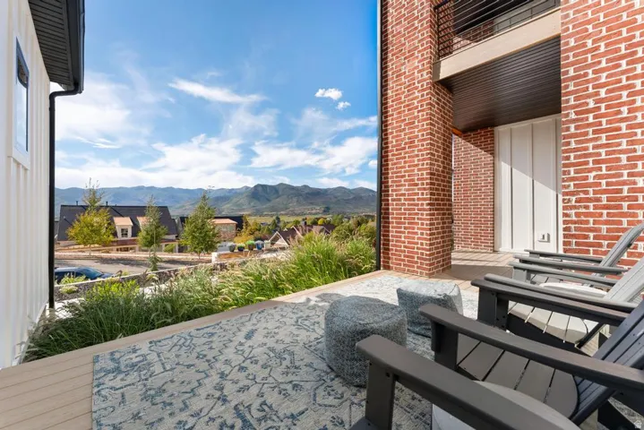 Outdoor terrace featuring a brick exterior and wood-finish decking