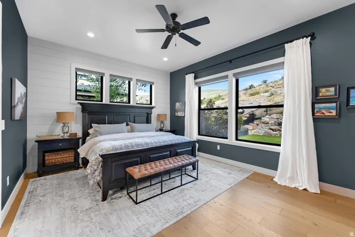 Light wood-finish flooring, recessed lighting, and a ceiling fan with light fixture