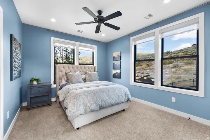 Recessed lighting, ceiling fan, and dual pane windows with white trim