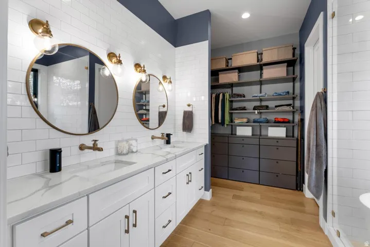 Dual vanity with wall-mounted faucets and round mirrors