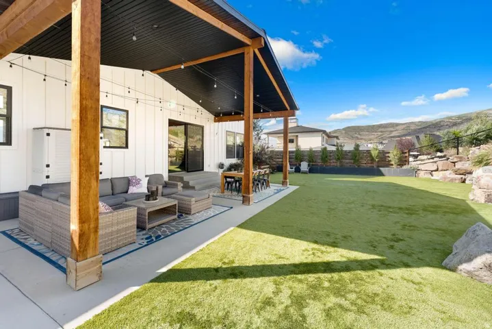 Spacious covered patio with exposed wood beams