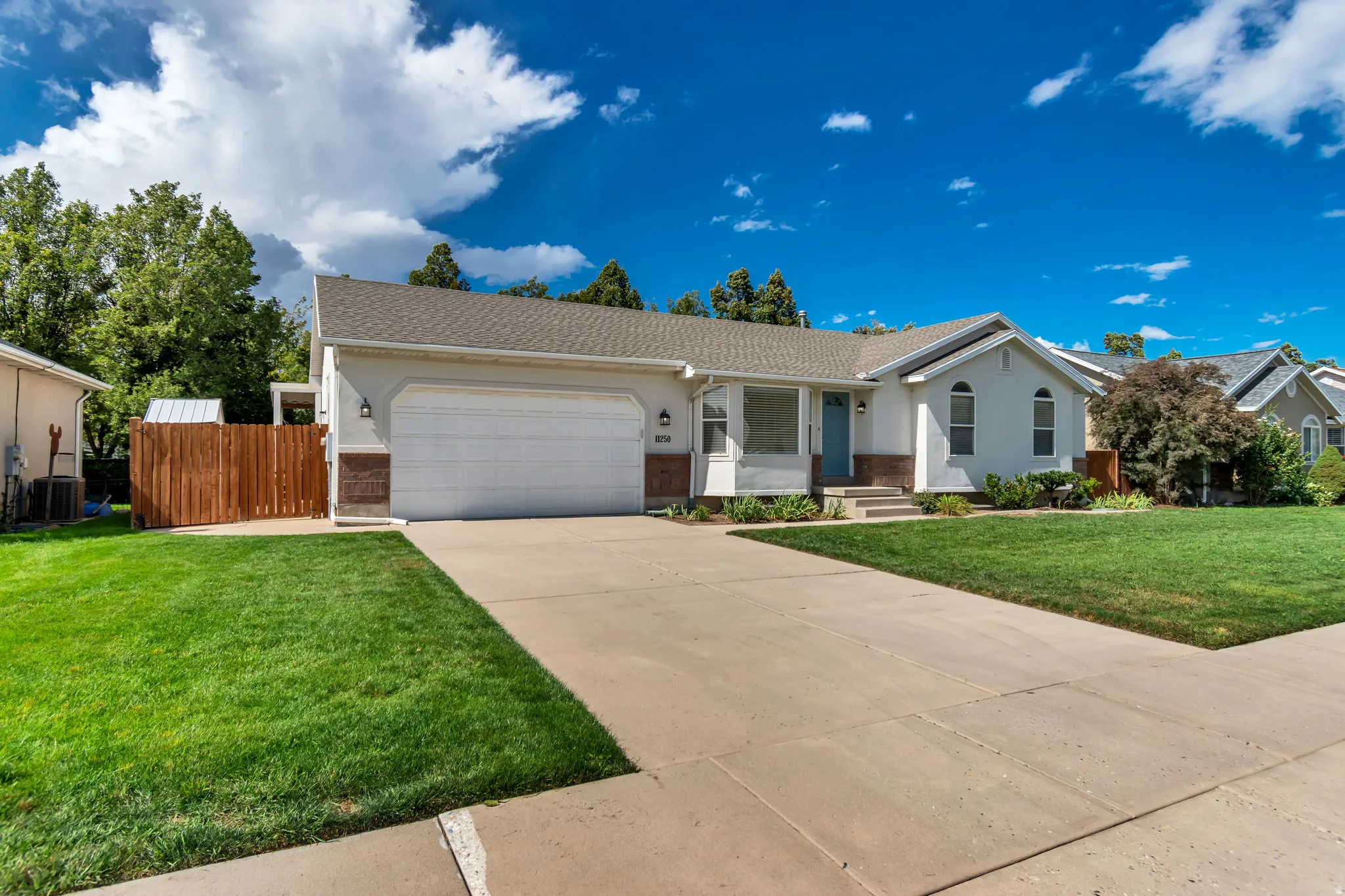 Concrete driveway leading to a two-car garage