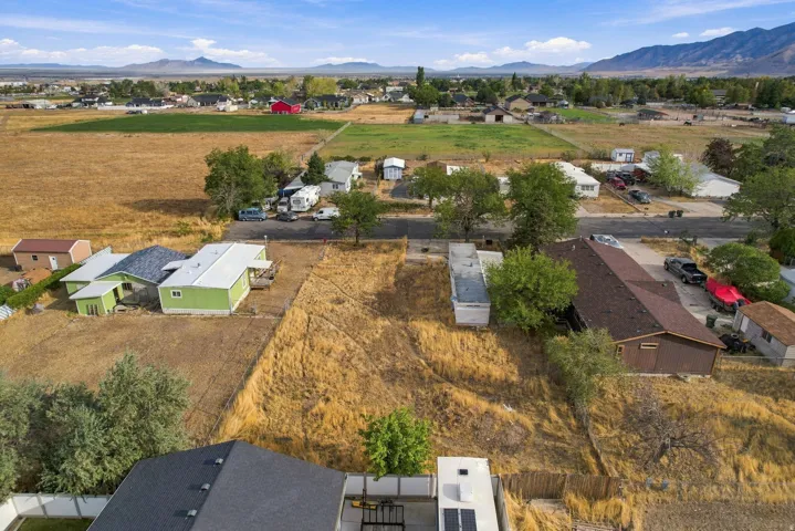 Expansive undeveloped lot with surrounding residential properties and agricultural land