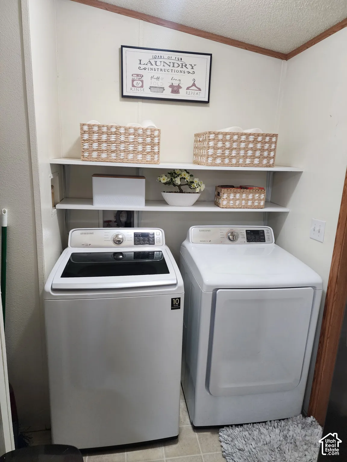 Laundry area featuring dual white built-in shelving units