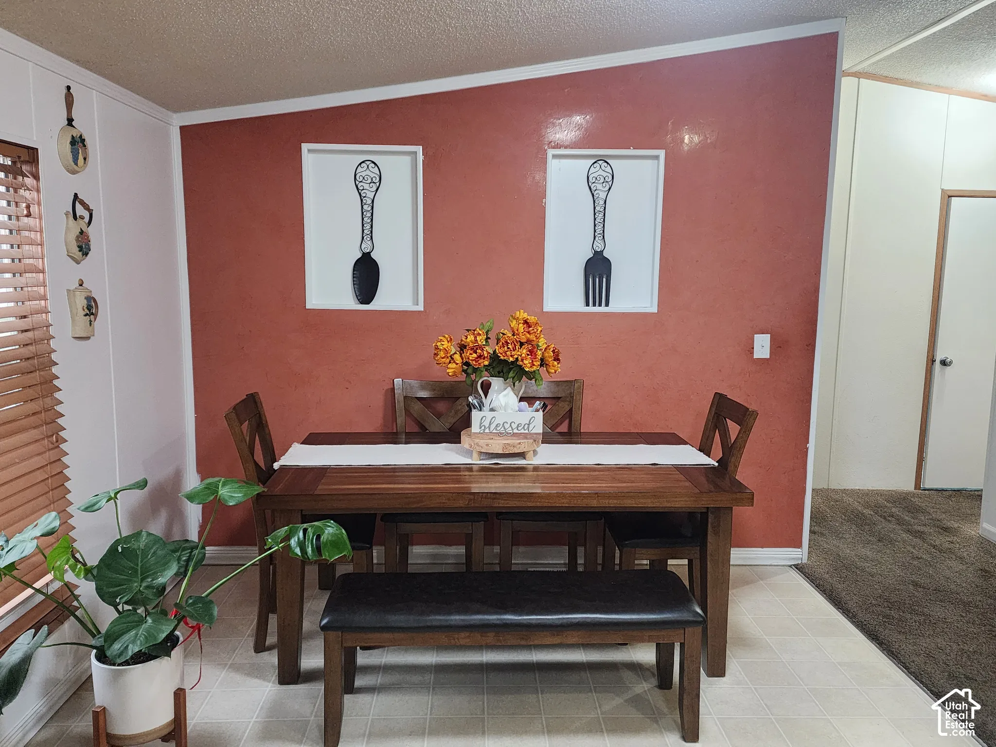 Accent wall featuring a textured terra cotta finish, two recessed wall niches, and wood-finish horizontal slat blinds