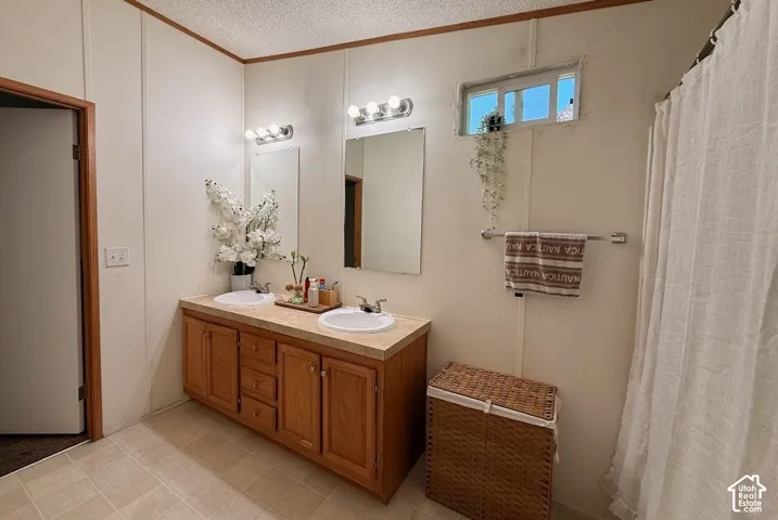 Double vanity with wood-finish cabinetry, dual undermount sinks, and a laminate countertop