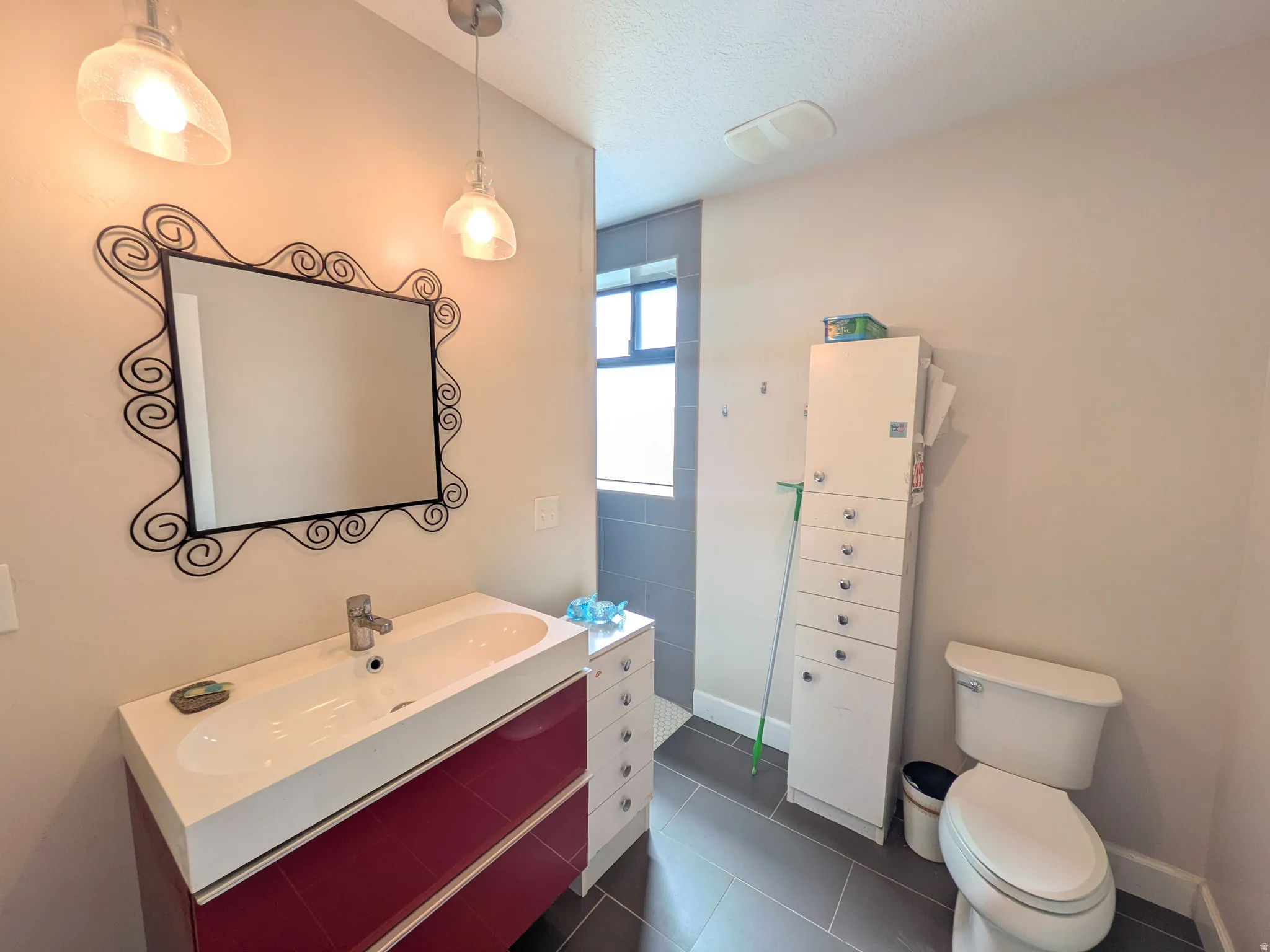 Modern vanity with integrated sink, chrome faucet, and decorative mirror
