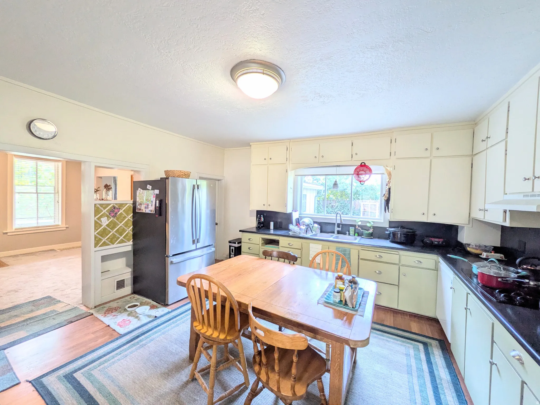 Kitchen with ample cabinetry and a window over the sink