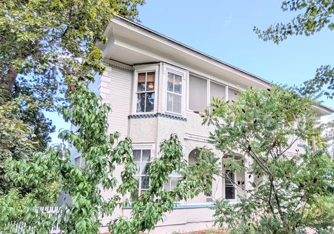White clapboard siding with decorative trim