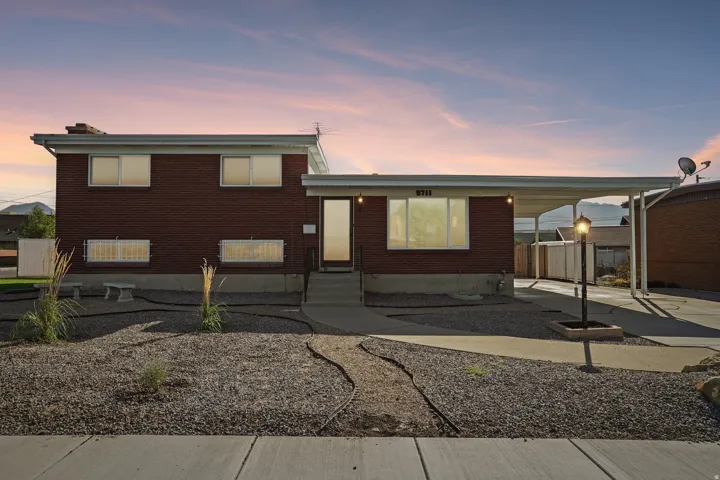 Brick exterior with a covered carport
