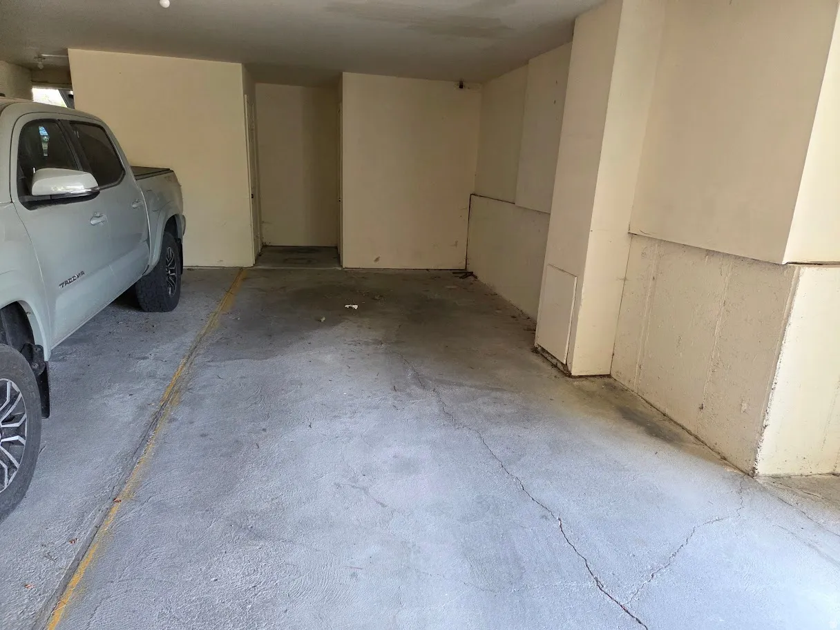 Parking space and entrance to storage unit in garage