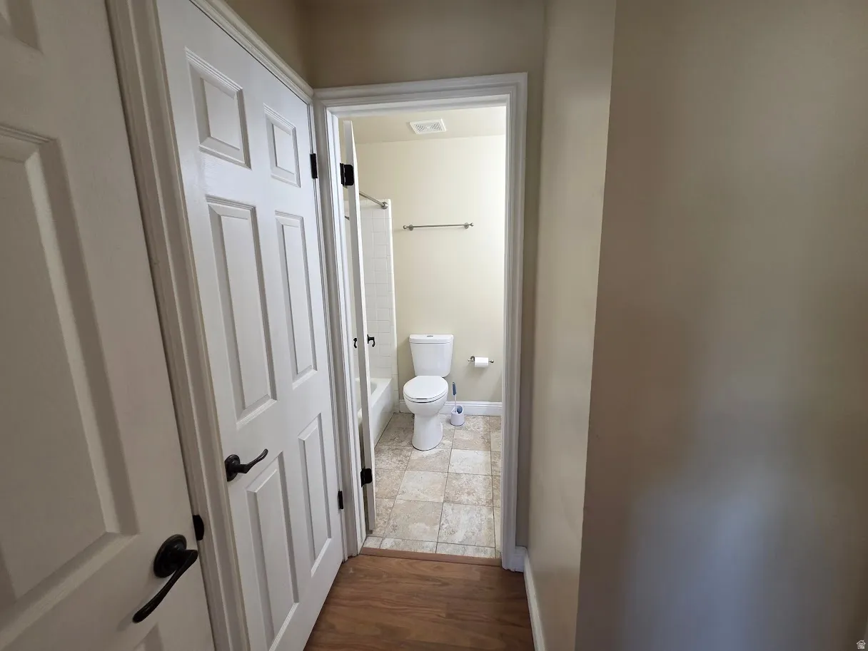 Main Bathroom with tile flooring, white fixtures, and a shower/tub combination
