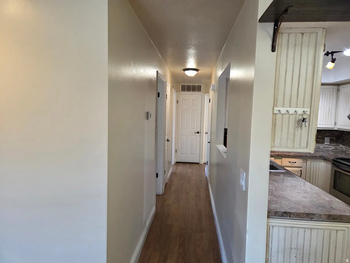 Wood-finish flooring throughout the hallway