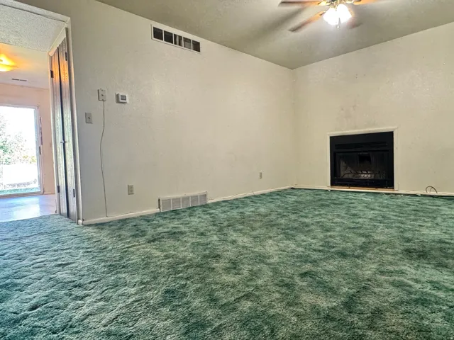 Unit 1 Family room with view into kitchen and backyard.