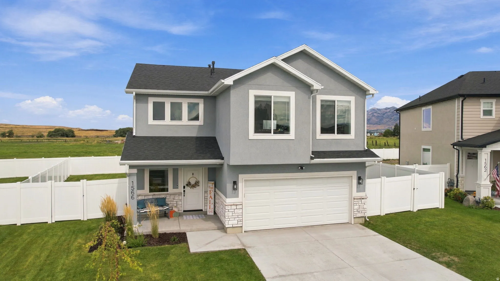 Contemporary two-story residence featuring a gray exterior and white trim