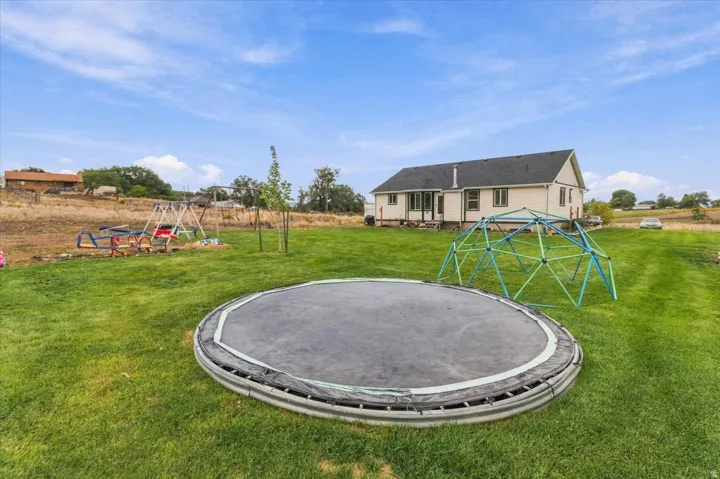 Expansive rear yard with a manicured lawn