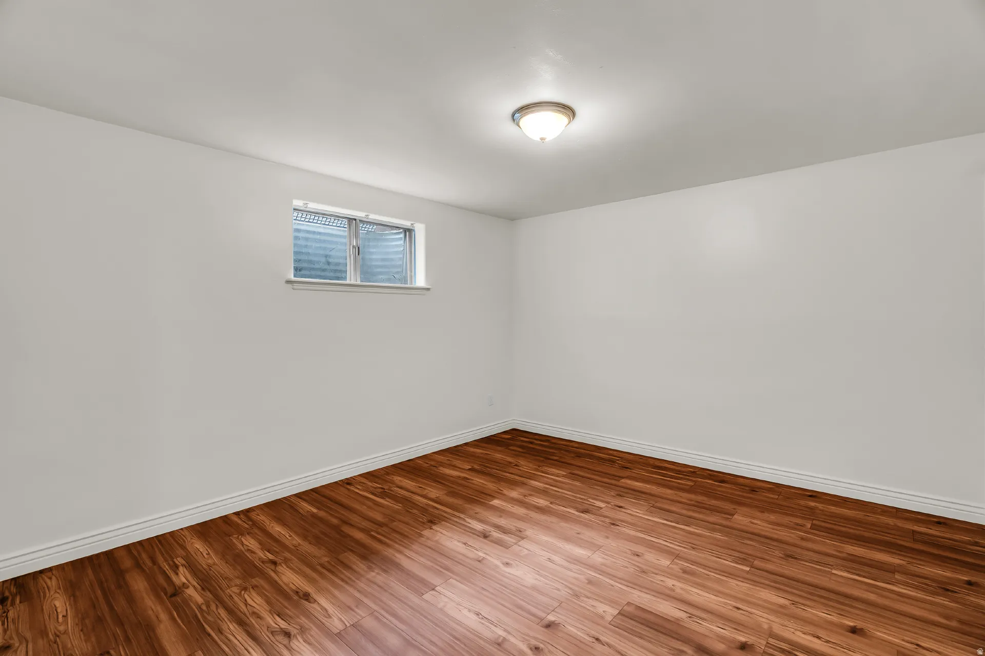 Wood-finish flooring with white baseboards