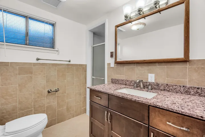Wood-finish vanity with an integrated sink and light-toned countertop