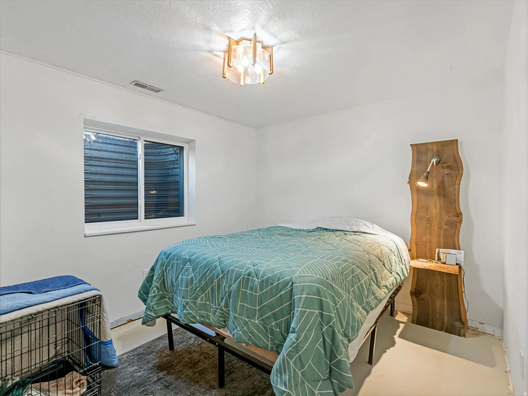 Recessed window with white trim, modern ceiling light fixture, and solid-color walls