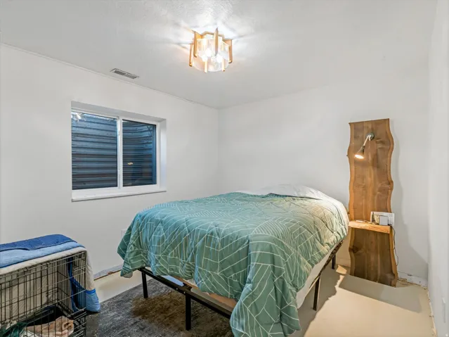 Recessed window with white trim, modern ceiling light fixture, and solid-color walls