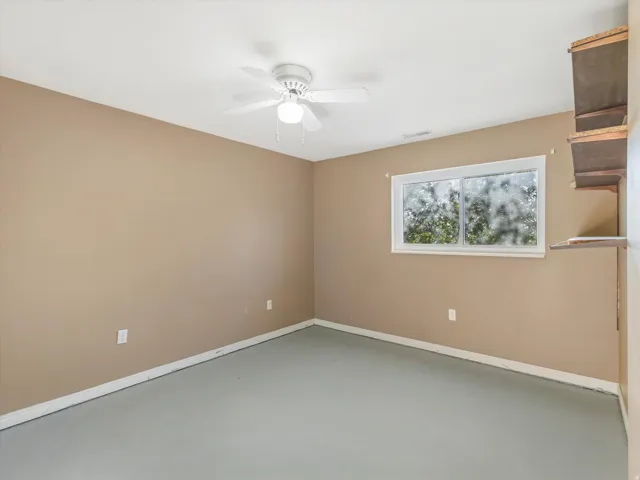Recessed window, ceiling fan, and built-in shelving