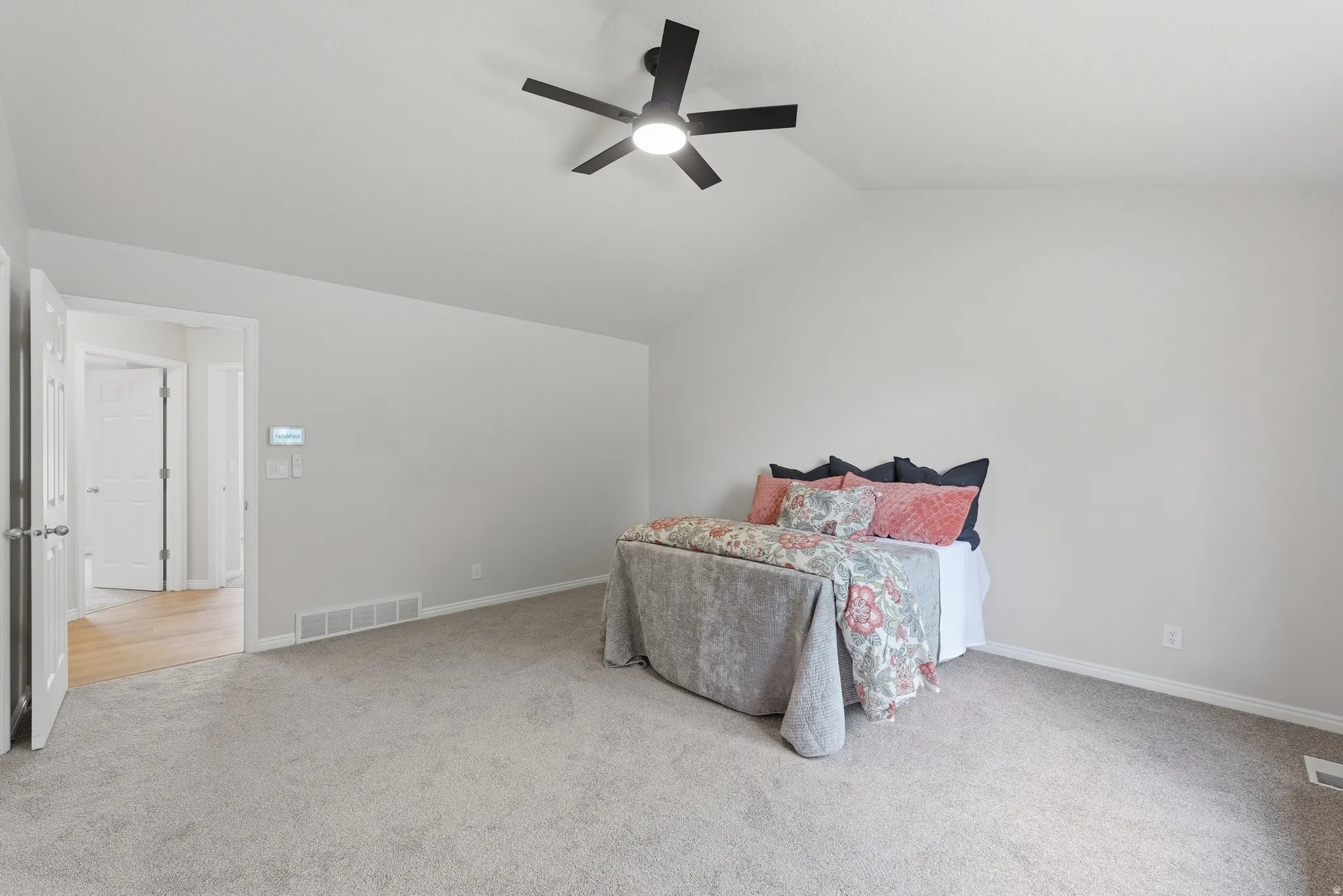Primary bedroom with vaulted ceiling and ensuite bath